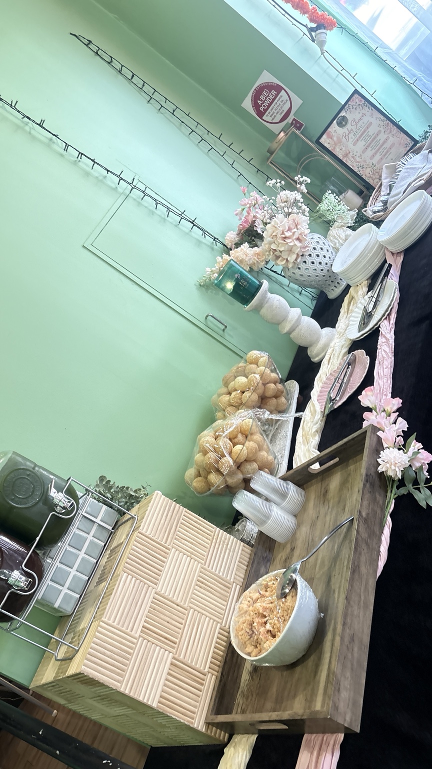 Baby shower buffet station with pani puri flowers tableware and cold drinks at Aura Indian Cuisine