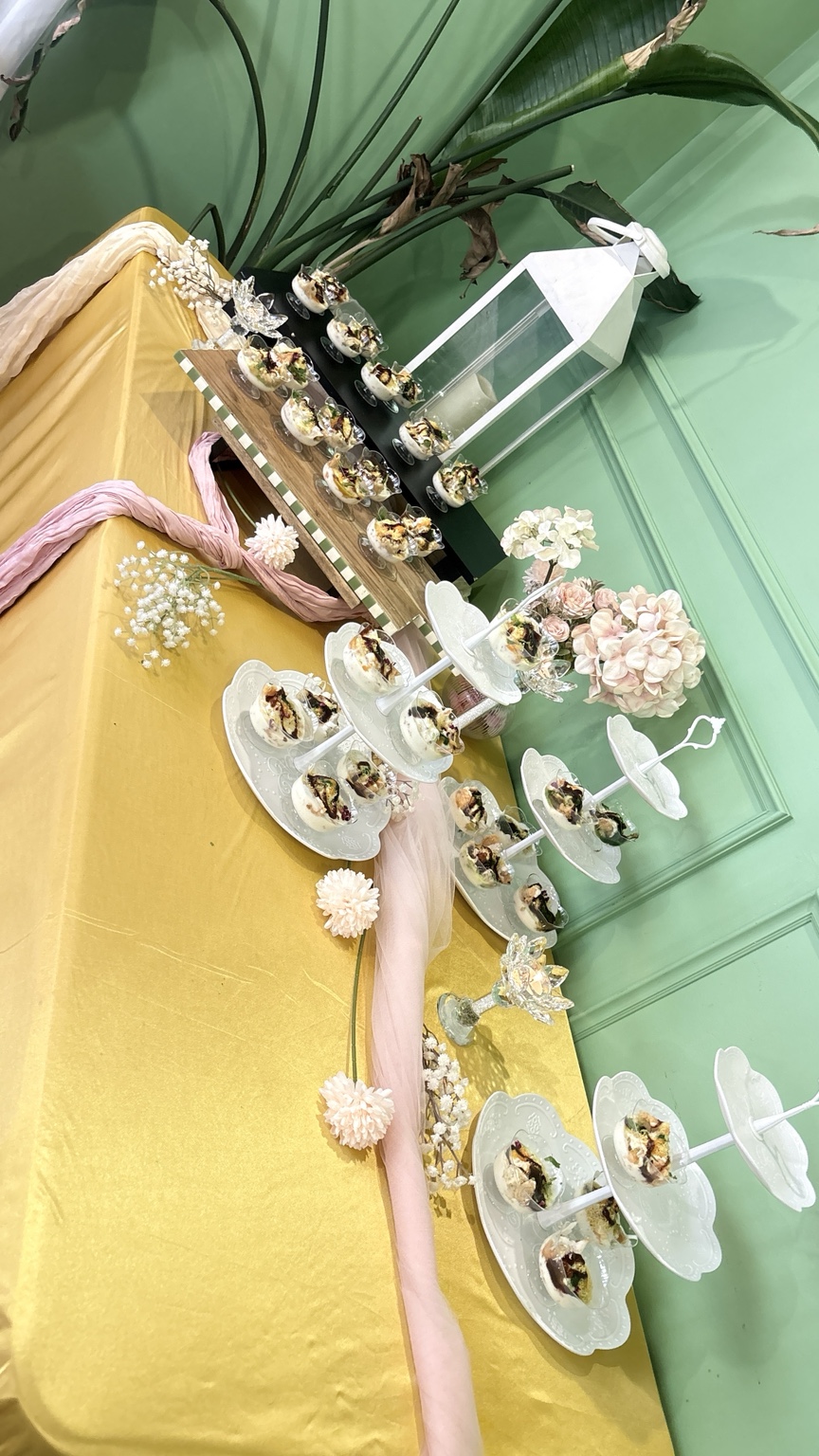 Individual grazing cups displayed on decorated stands for a baby shower at Aura Indian Cuisine